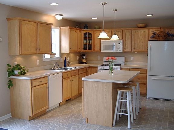 Sunny kitchen with tons of cabinet space and 5' cabinet island