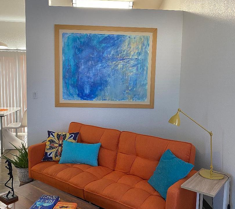 Stylish architectural features include vaulted ceilings. This photo shows living area opening into dining area.