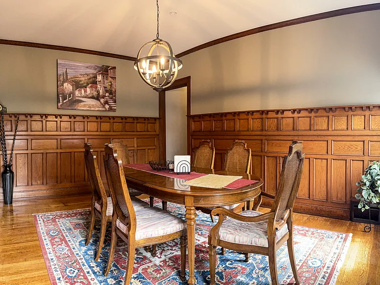 [Dining room] Features all-original wood paneling, and stained-glass window.