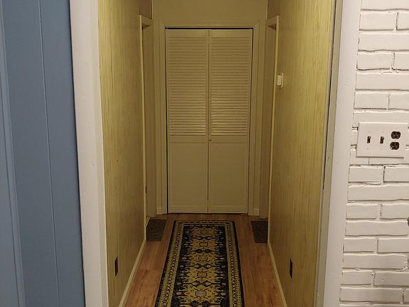 Hallway to bedrooms. Washroom pictured ahead.