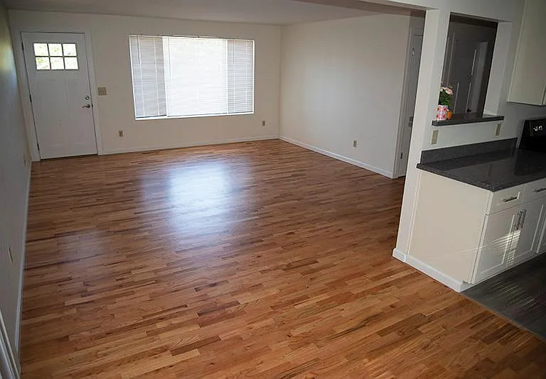 Large living room with good lighting. Freshly-refinished original hardwood floors, spacious dining room