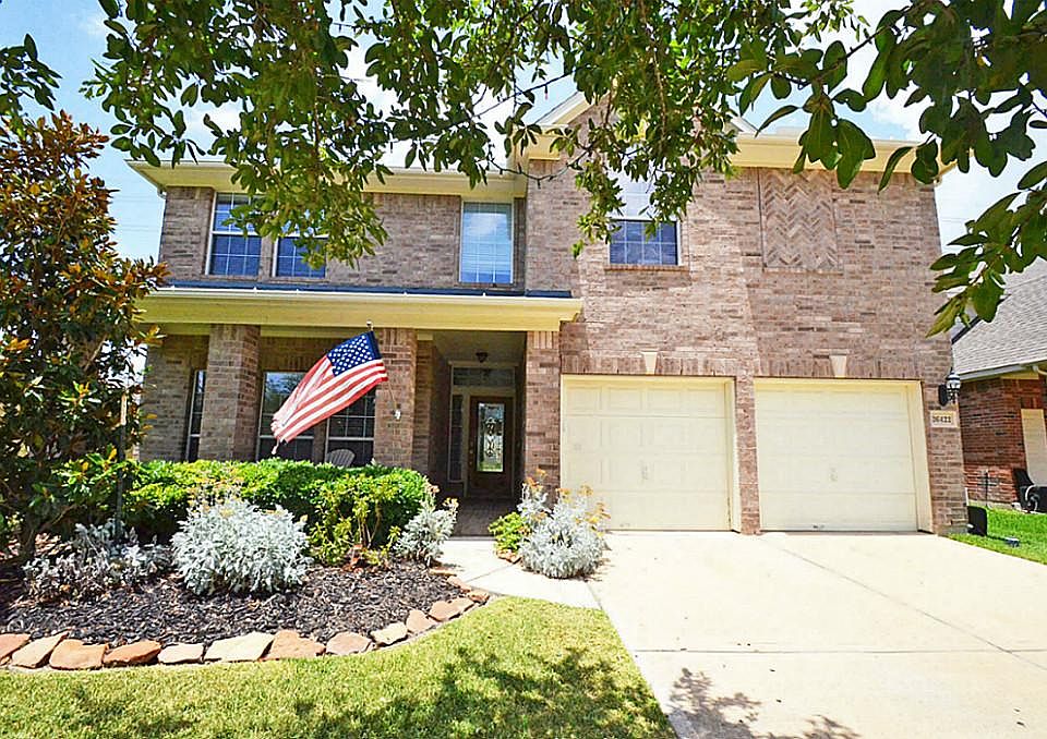 Beautiful front elevation with large brick covered porch.