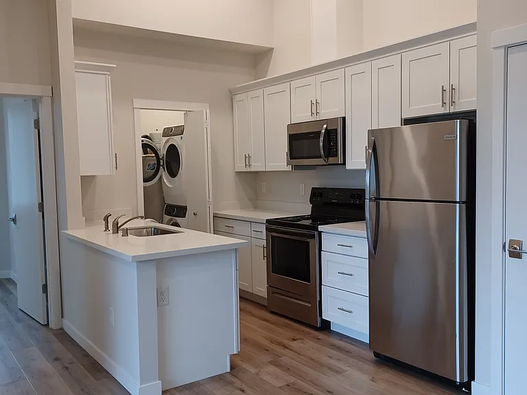 Kitchen similar without 12' ceilings shown. Ceiling is 9' in available unit. Actual pictures next week, floor layout is identicle.