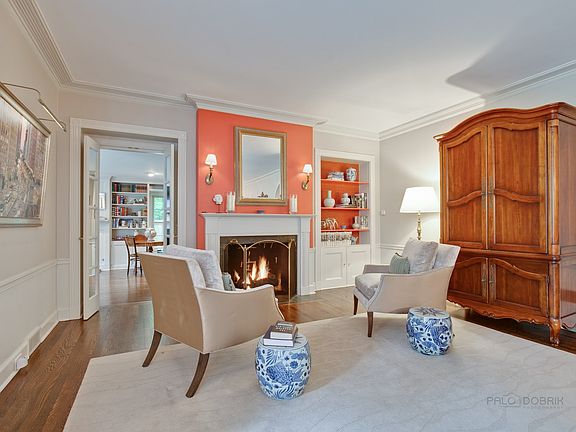 The living room has one of three fireplaces in the home