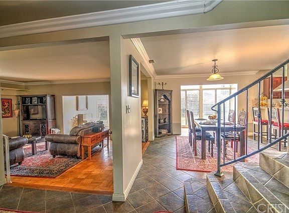 Entry with tile leads to the step down living room and formal dining.