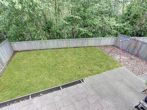 spacious backyard with a swing set for ample playtime for your kids.Added privacy with green belt behind.