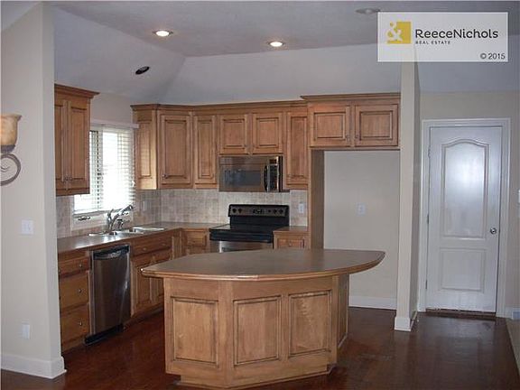 Updated Kitchen with island bar, hardwood floors, and stainless steal appliances