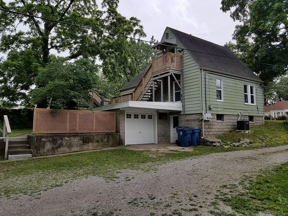 Driveway side. Garage for upper unit. Regular door into the basement, used by lower unit.