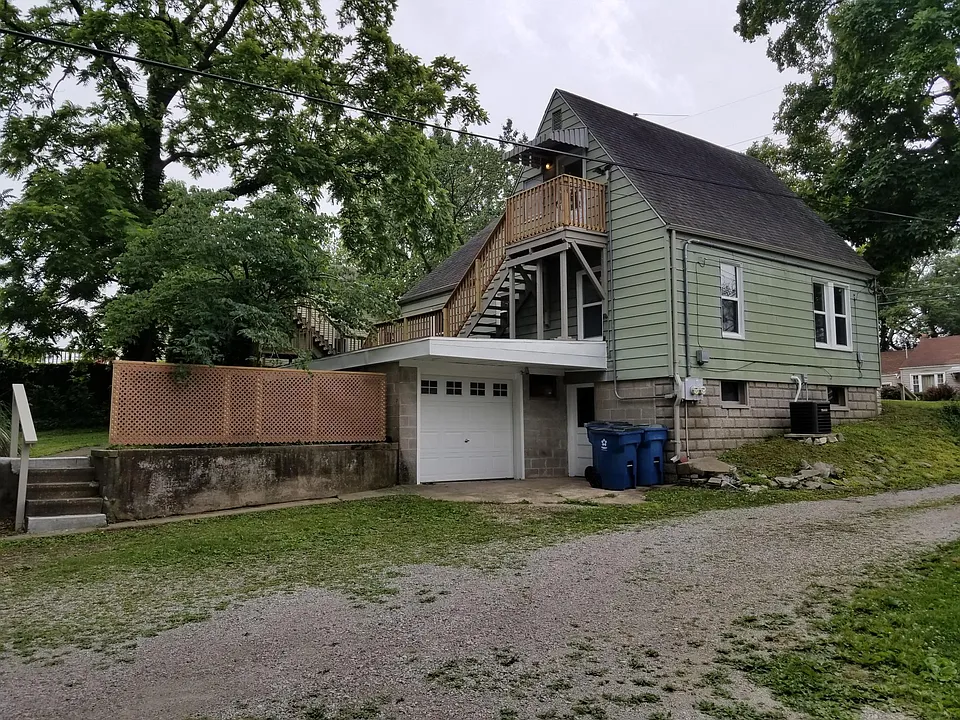 Driveway side. Garage for upper unit. Regular door into the basement, used by lower unit.