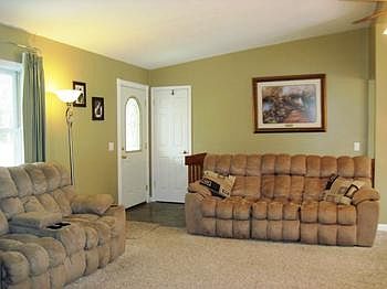vaulted living room, opens into dining area.