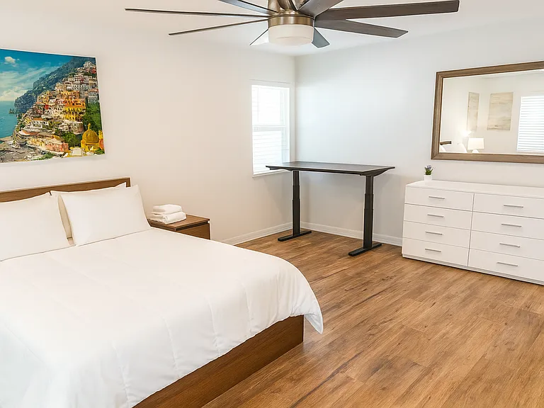 Spacious master bedroom with comfy queen bed and 58" 4K Smart TV.