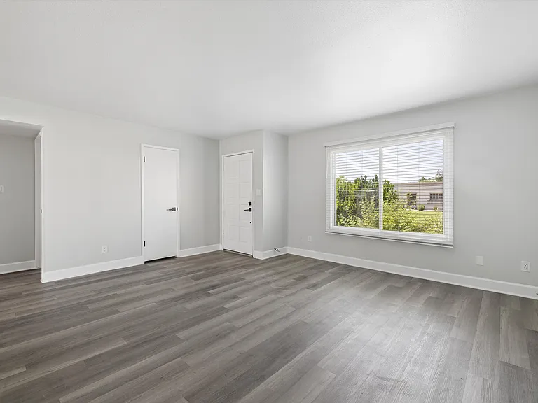 Living room and front door - faces into pool/complex