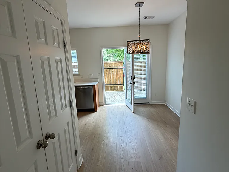 View of your large pantry on the left and arch to your kitchen.