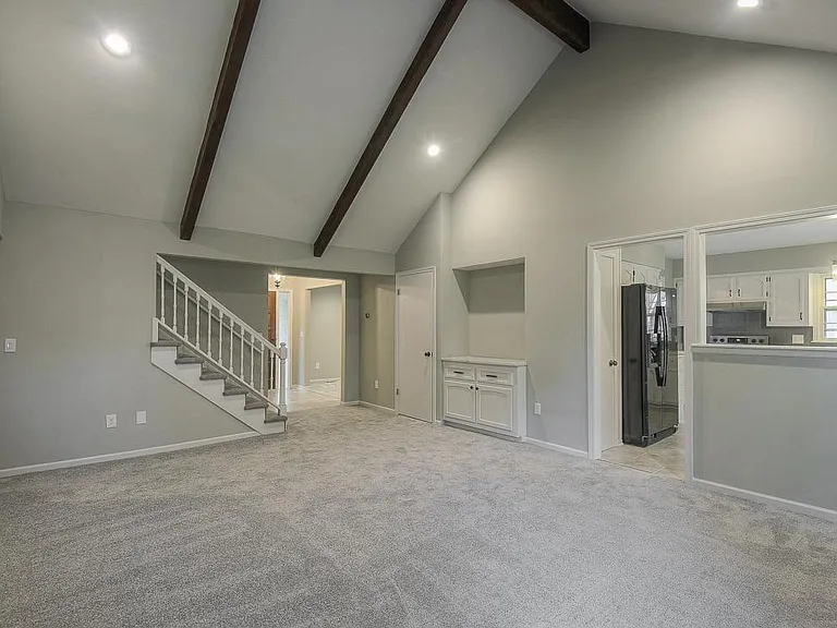The family room flows into the kitchen and features high ceilings and the warmth and openness throughout the home. Closet and storage built in for a bar area or games and DVDs at your fingertips.