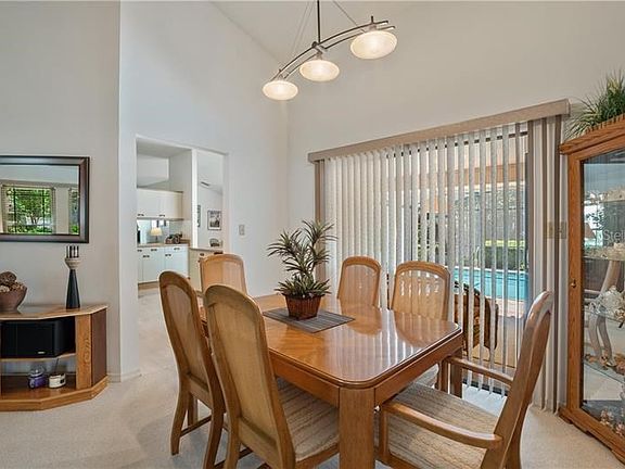 Formal dining room with sliders to lanai and pool