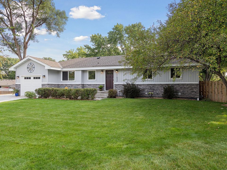 Front of home, beautiful front lawn. Flowering crab apple tree.