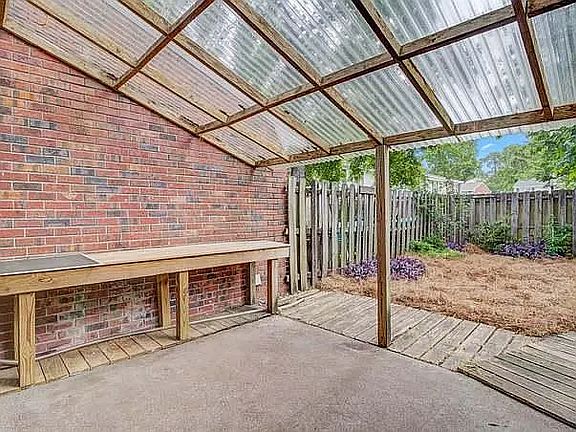 The pine straw has now been replaced by grass and the wooden walkway has been replaced with a gravel path to back gate.
