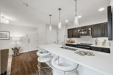 Counter seating for extra seating space with laundry and garage directly off kitchen.