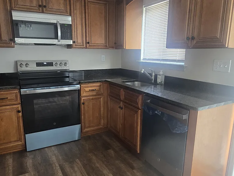 New kitchen with new appliances and granite countertops