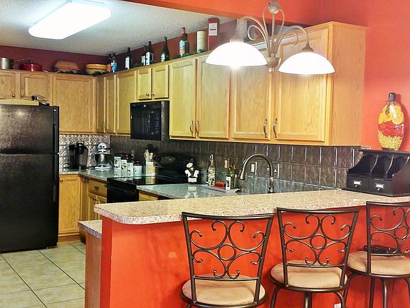 Kitchen with granite countertops and a breakfast bar.