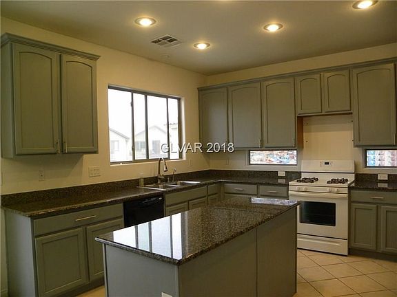Island Kitchen with granite counter tops, recessed lighting & tile floors