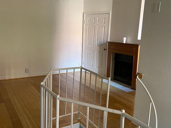Looking from dining area toward living space, fireplace (not operable) and main floor closet storage.