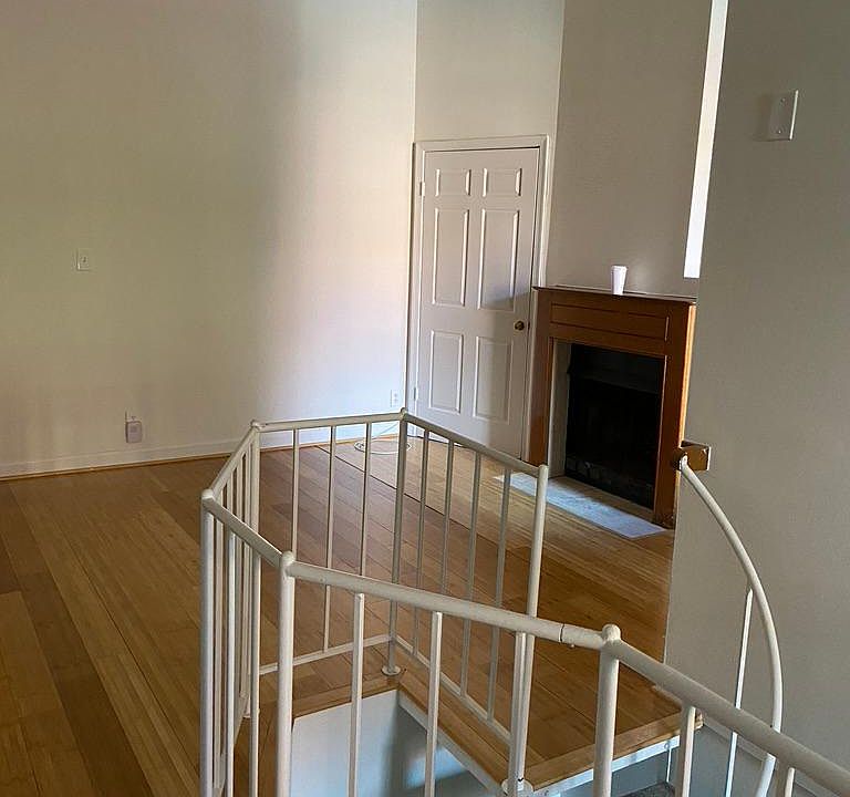 Looking from dining area toward living space, fireplace (not operable) and main floor closet storage.