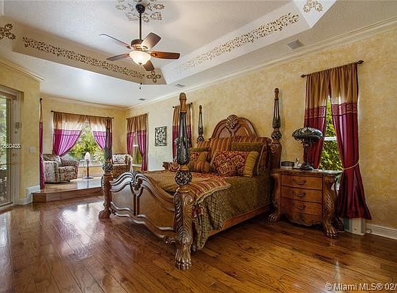 LOOK AT THESE GORGEOUS WOOD FLOORS IN THE HUGE MASTER BEDROOM!  STEP UP TO YOUR OWN SITTING AREA OVERLOOKING THE LUSH LANDSCAPIN