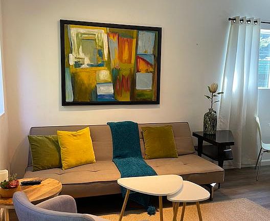Living room area with woven area rug.