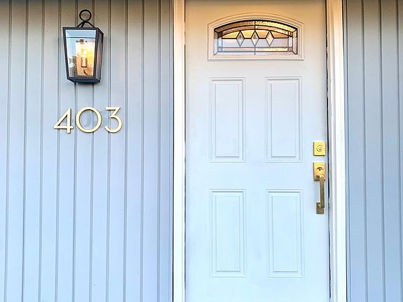 Front door and mailbox area has new satin brass and iron hardware.