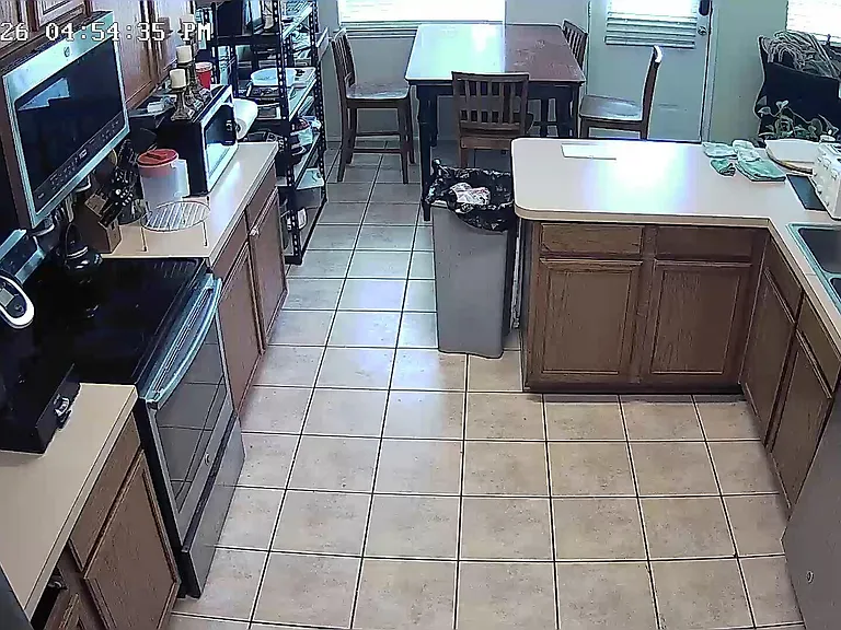 Functional eat-in kitchen with ample cabinet storage, full-size range, double sink, and dishwasher for easy daily meals.