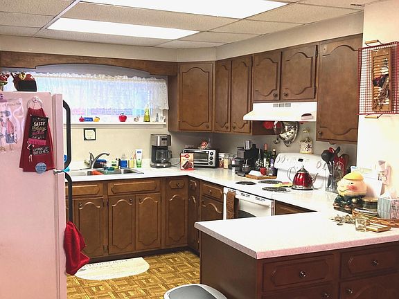 Large kitchen, lots of storage on all sides. Perfect for someone who enjoys cooking. Open to the dining area and view of the bay window.