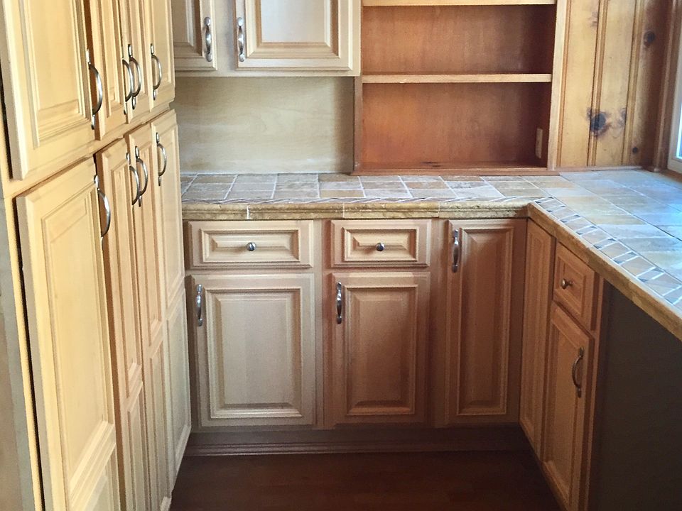 This is an old butler pantry that is great for extra storage. The windows to the right overlook the deck