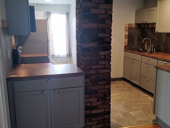 View of the kitchen from the living room. The window provides a great cross breeze and you can enjoy beautiful sunsets. Amazing fall colors too.