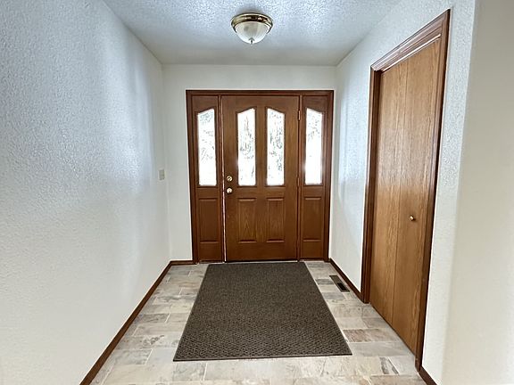 Foyer, main entrance and one of the three hall closets that are available at the front entry.