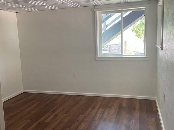 Bedroom 1 with 2 windows- one of them an escape window. Large double closet is to the left