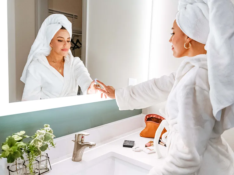 Bathroom vanity with lighted mirror