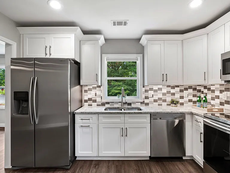 Beautiful, brand new kitchen with SS appliances, granite counters, and white shaker cabinets.
