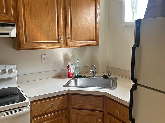 Cathedral oak kitchen with stove, disposal and refrigerator