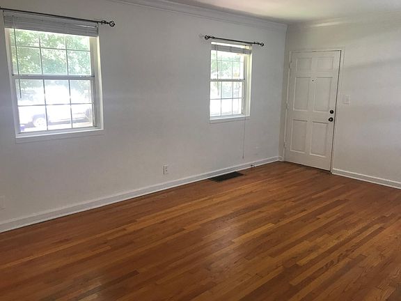 Bright living room. Windows with 2" blinds, and coat closet.