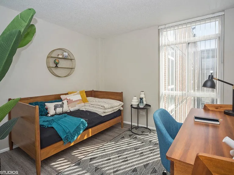 Spacious second bedroom with floor to ceiling window