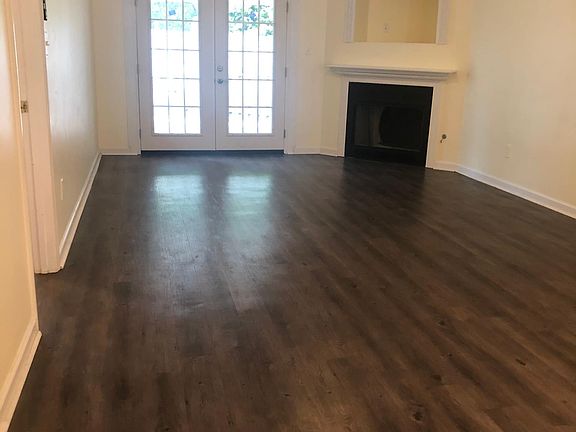 Living Room with ceiling fan, French doors and fireplace