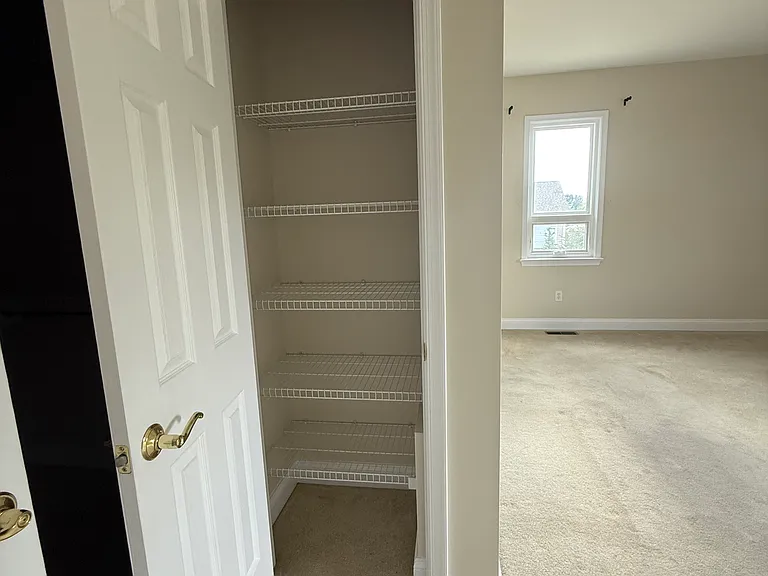 closet in downstairs primary bedroom suite