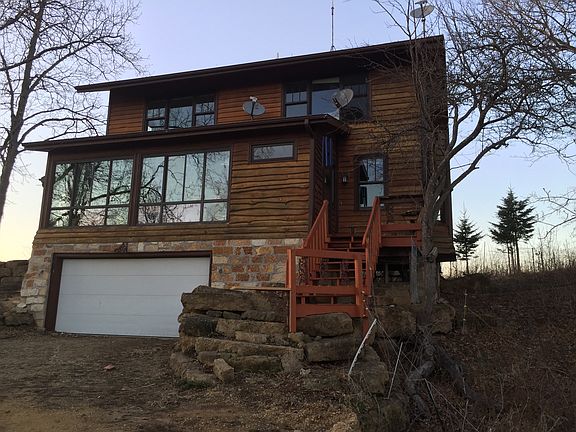 South facing entrance, greenhouse and garage