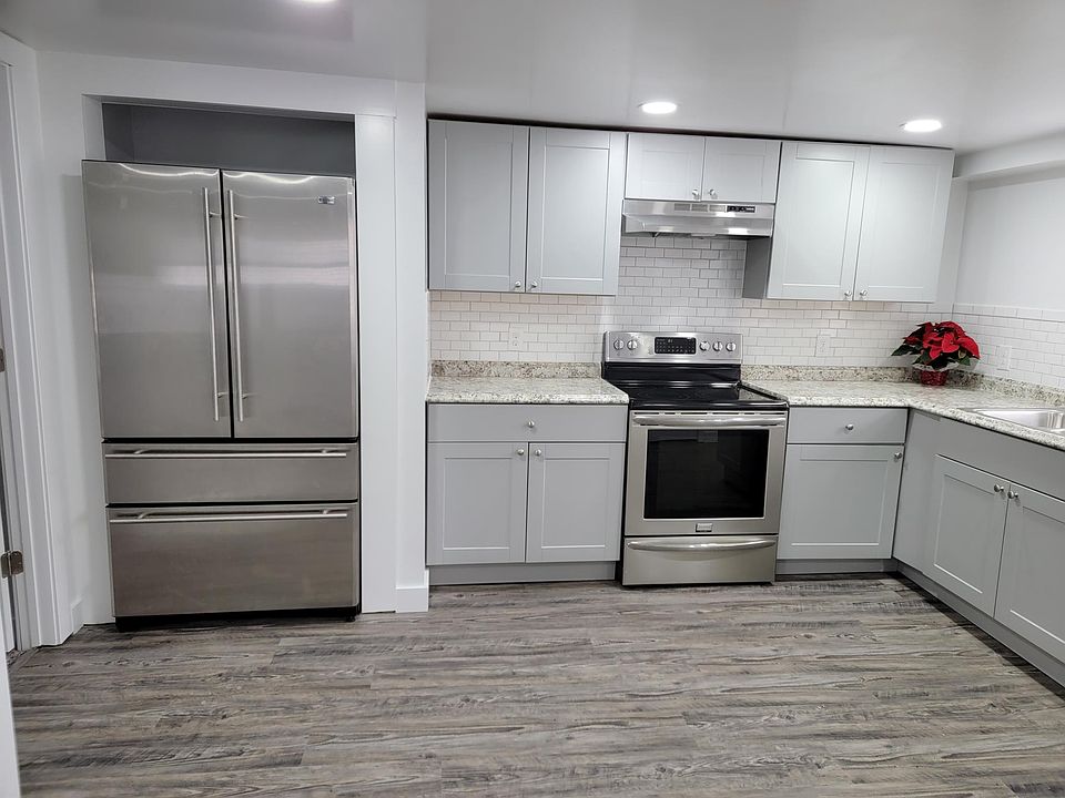 Designer kitchen includes stainless steel refrigerator, stove and dishwasher.