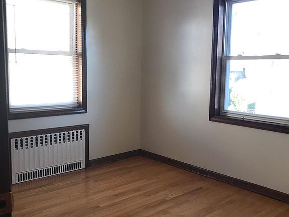 1st bedroom which includes 2 windows and 1 sliding door closet.