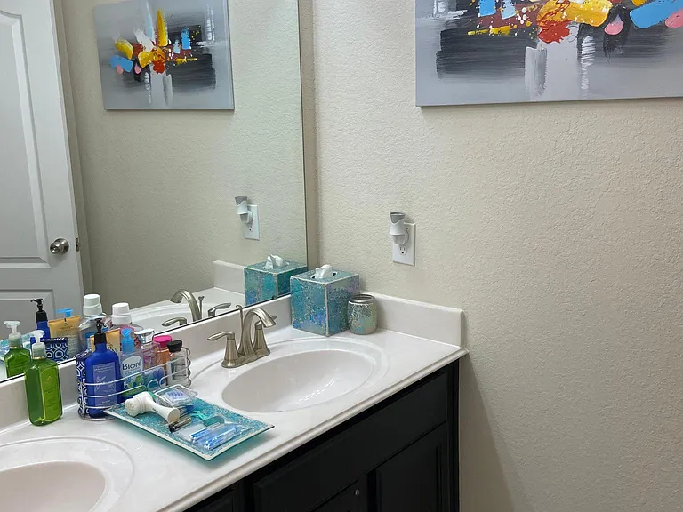 Hallway bathroom double sinks are separated from toilet and tub. Separate doors. This bathroom connects to the fourth bedroom. All doors through the house have locks