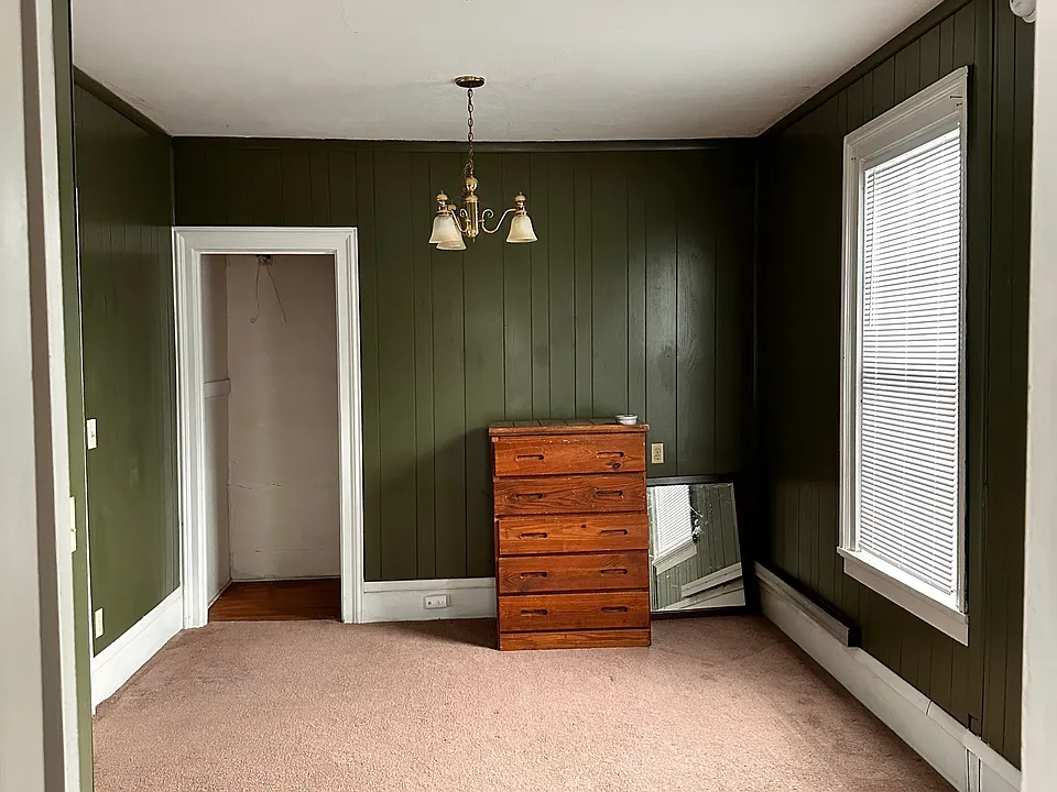 Large bedroom with two closets and large window.