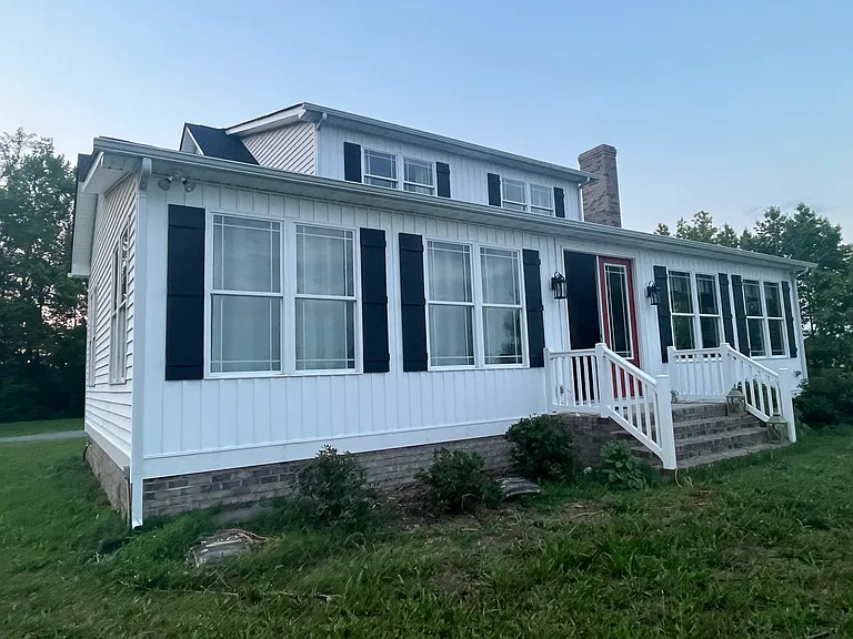 The back side of the house with the master bedroom to the left and the living room to the right on the first floor. The large second floor windows are in each of those 2 bedrooms - every one of these rooms has breathtaking views of the river.