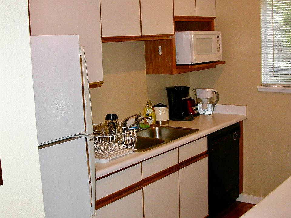 Kitchen with refrigerator, gas range, dishwasher and microwave.